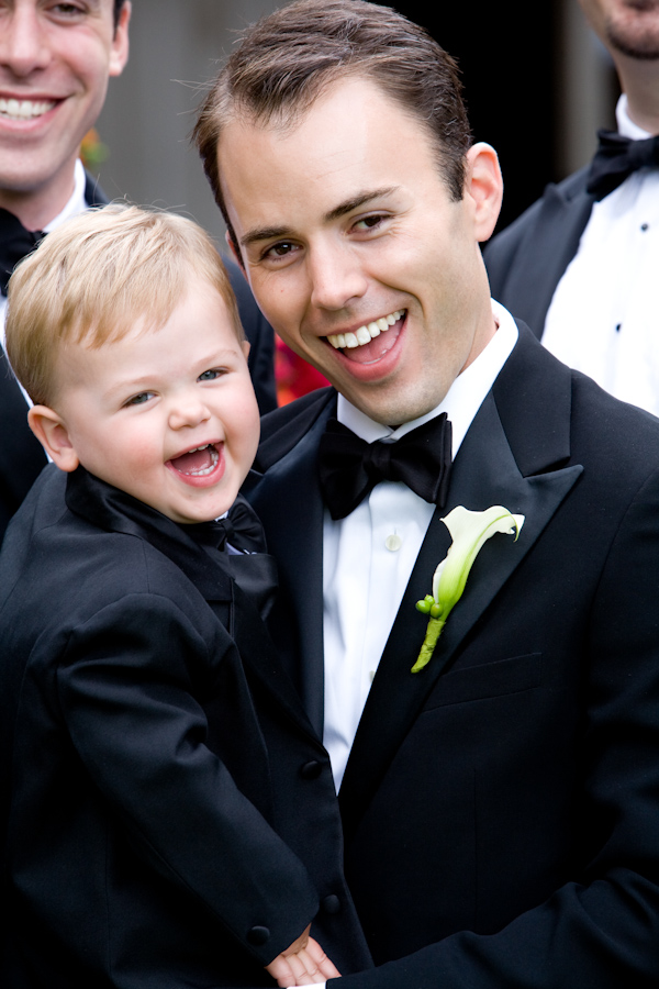 smiling groom holding adorable ring bearer - photo by Seattle based wedding photographers La Vie Photography